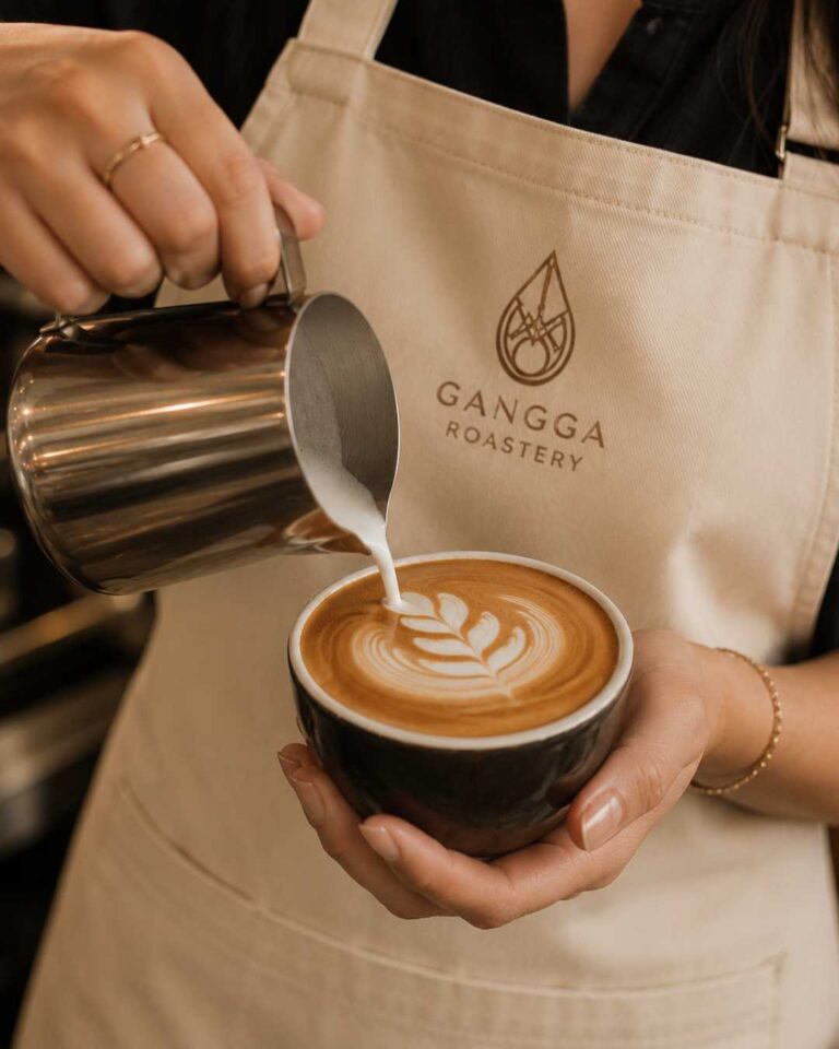 Professional latte art in a ceramic cup prepared with specialty coffee roasted by Gangga Roastery.